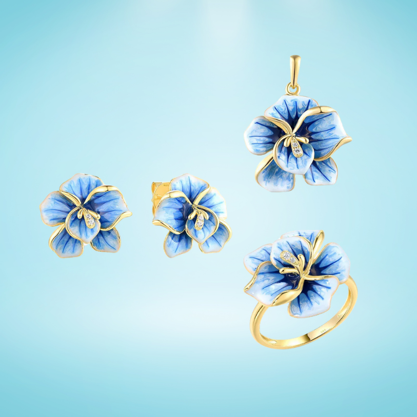 Jewelry set with hand-painted blue flower designs in gold-tone metal, featuring crystal accents