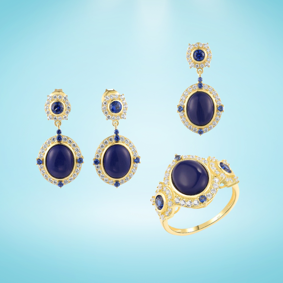 Gold jewelry set featuring oval deep blue stones with clear and sapphire-toned halo accents