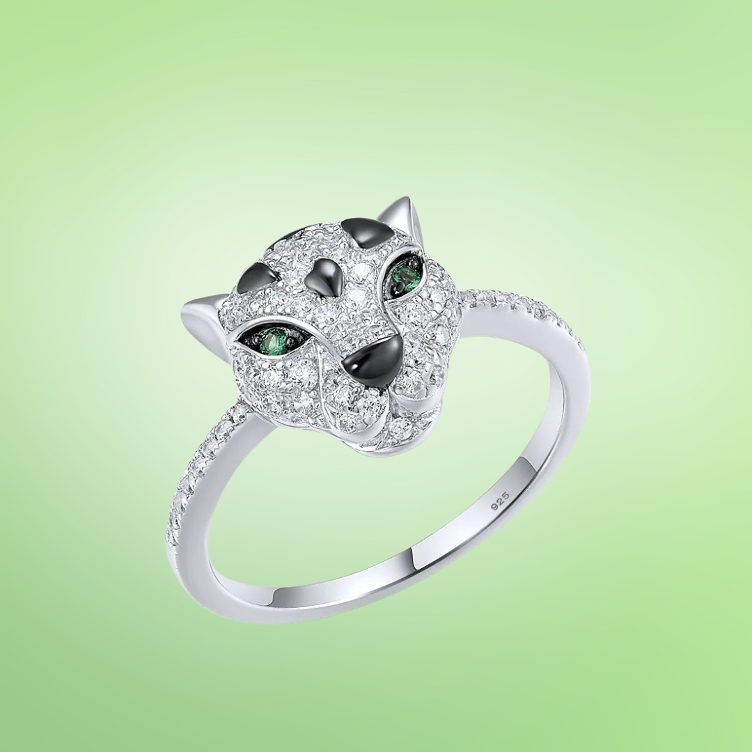 Silver ring featuring a panther head design with pavé stones and vivid green eyes