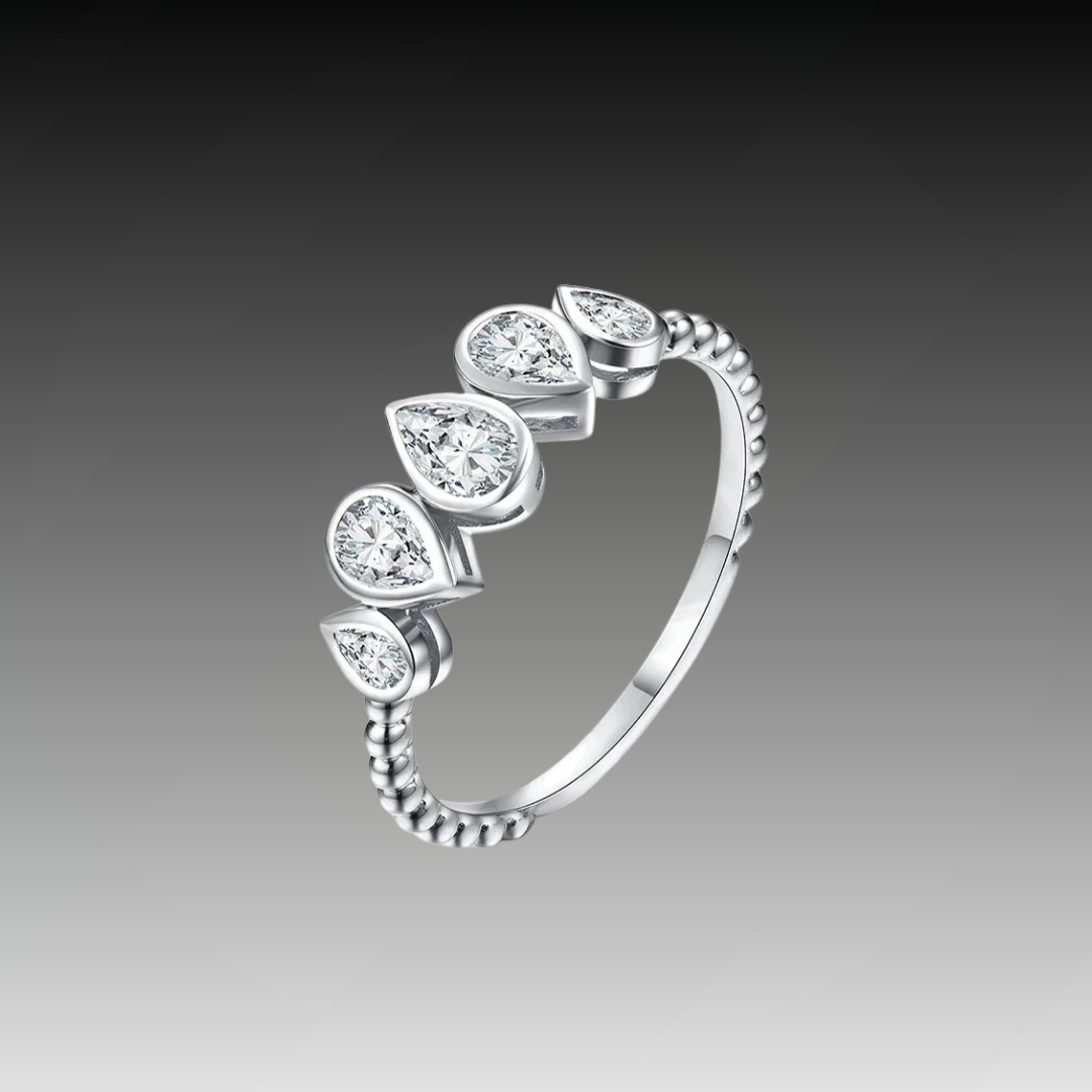 Delicate silver ring featuring five pear-cut stones in a row, with a beaded band design.