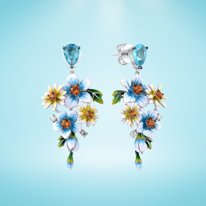 Sterling silver floral drop earrings with blue enamel flowers and orange gemstone centers