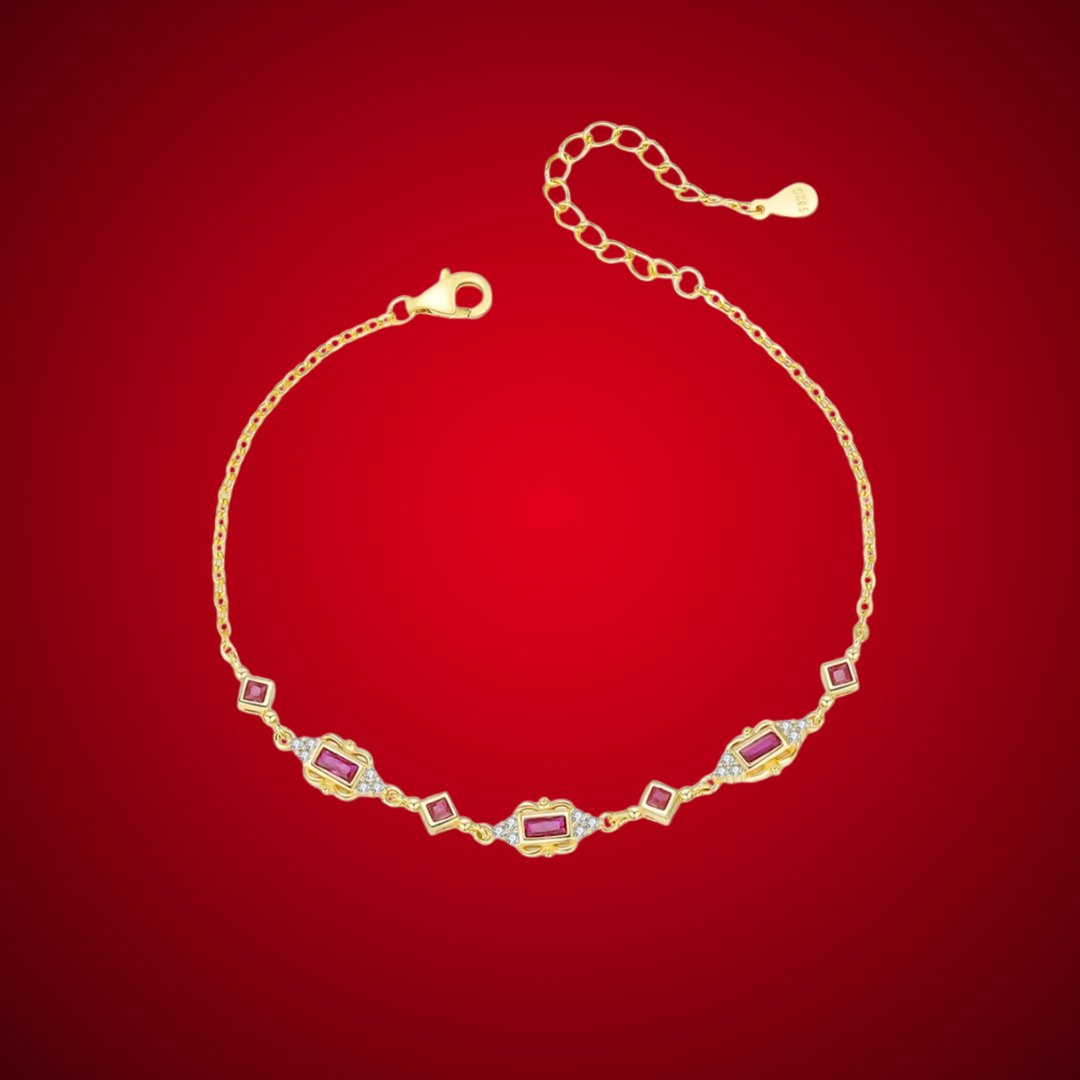 Gold-plated bracelet with ruby-red rectangular and diamond-shaped stones