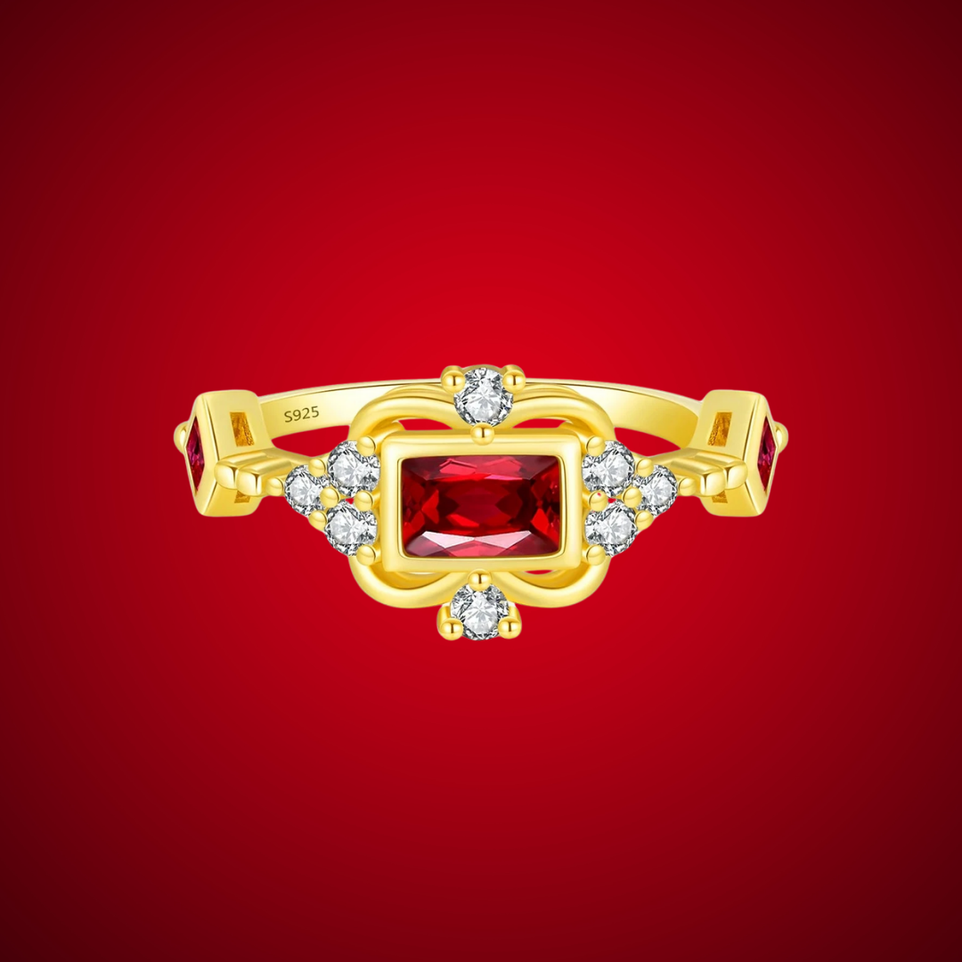 Gold-plated ring with rectangular ruby-red stone and vintage-inspired clear accents