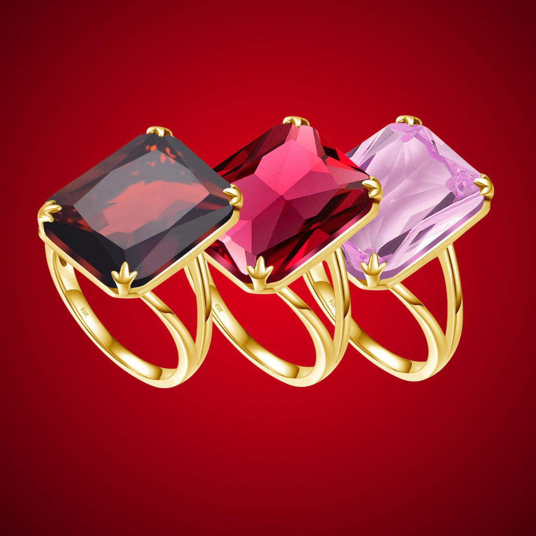 Three bold square-cut gemstone rings in red, crimson, and soft rose pink, set in gold-plated bands from the Rossa collection.