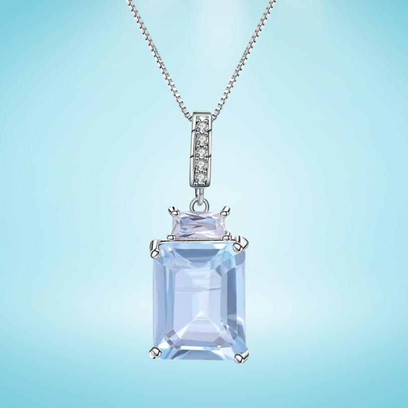 Sterling silver necklace with rectangular and baguette-cut light blue gemstones and a pavé-set bail