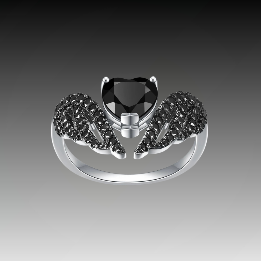 Sterling silver ring with a heart-shaped black gemstone flanked by pavé-set wing-like details, from the Ali Nere design.