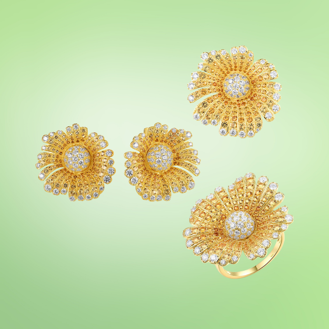 Gold-toned jewelry set with large daisy-like floral designs fully encrusted with clear crystals