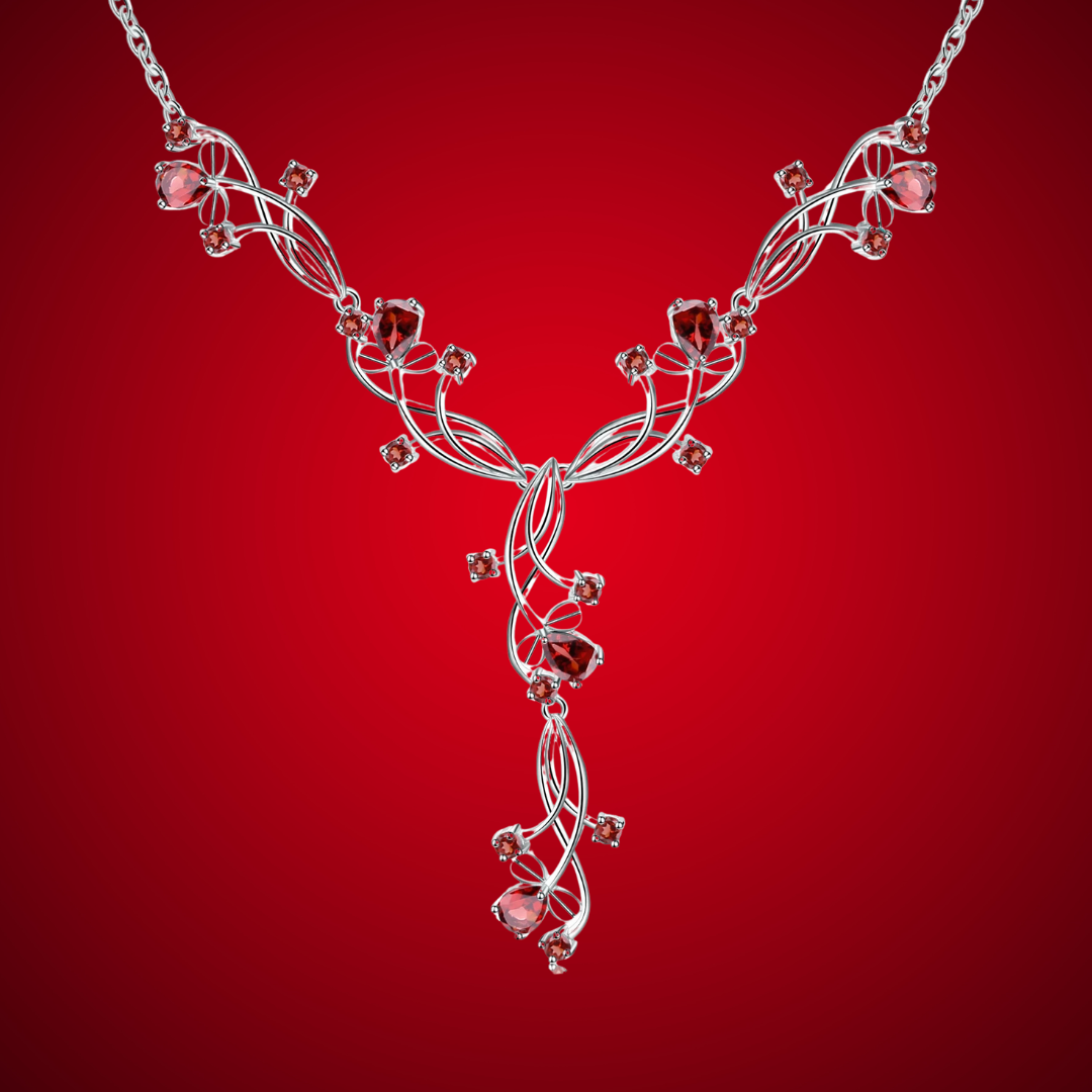 Silver necklace with a swirling vine-like structure, adorned with deep red gemstones arranged in floral and geometric clusters.
