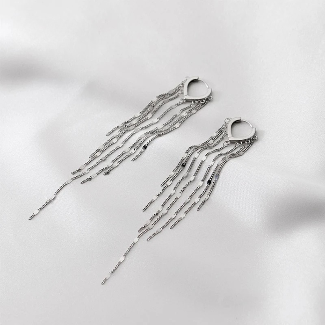 Silver earrings with multiple cascading chain strands from a teardrop-shaped base