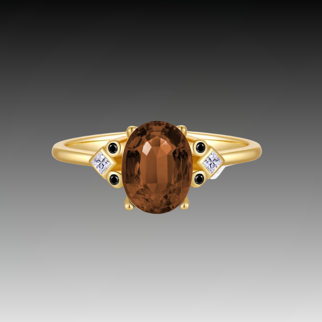Gold ring with large oval brown gemstone and black and white accent stones