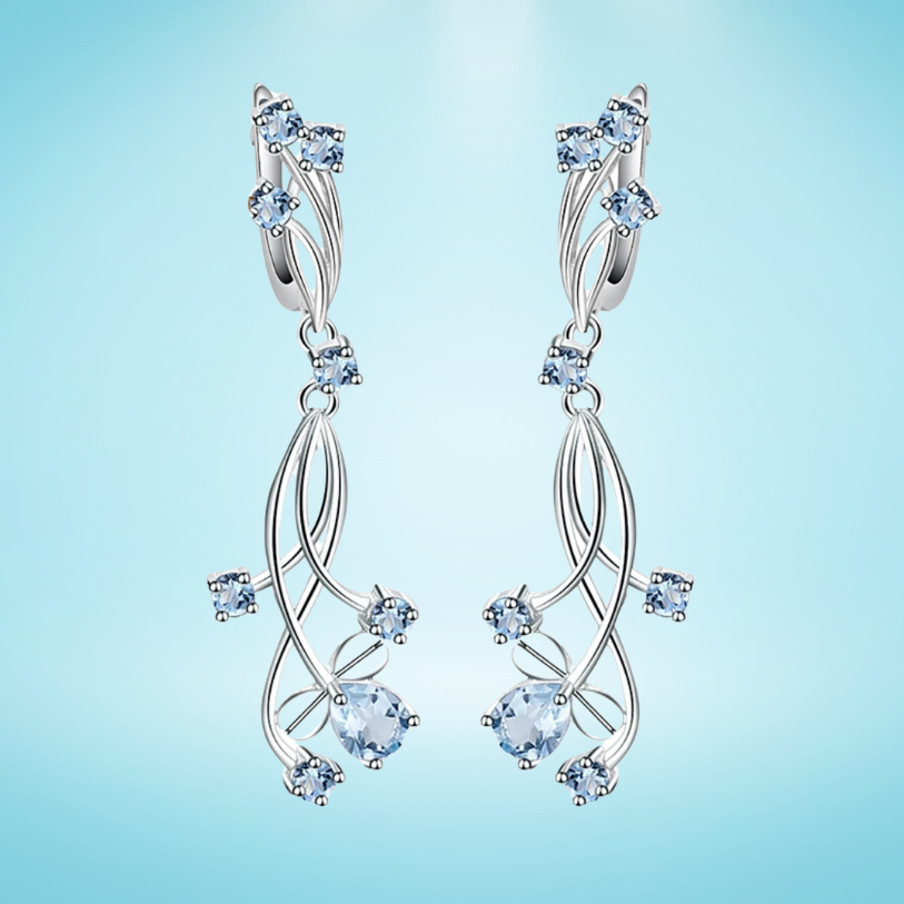 Sterling silver drop earrings with curved lines and scattered light blue gemstones resembling delicate flower petals