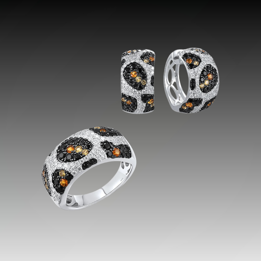 Matching jewelry set with leopard-inspired design in silver and gemstone accents, including ring and earrings, titled Pardus Lux.