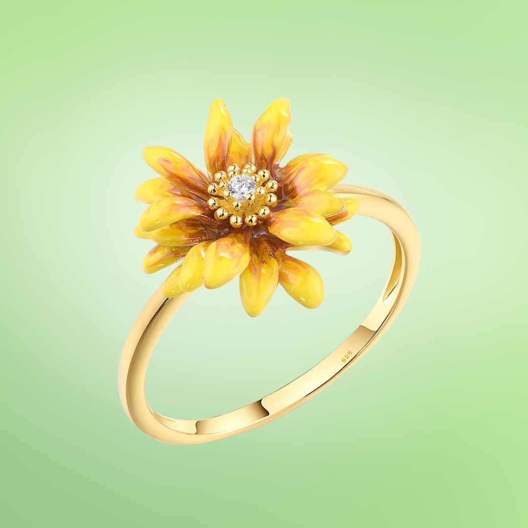 Yellow enamel flower ring with warm tones and central crystal accent