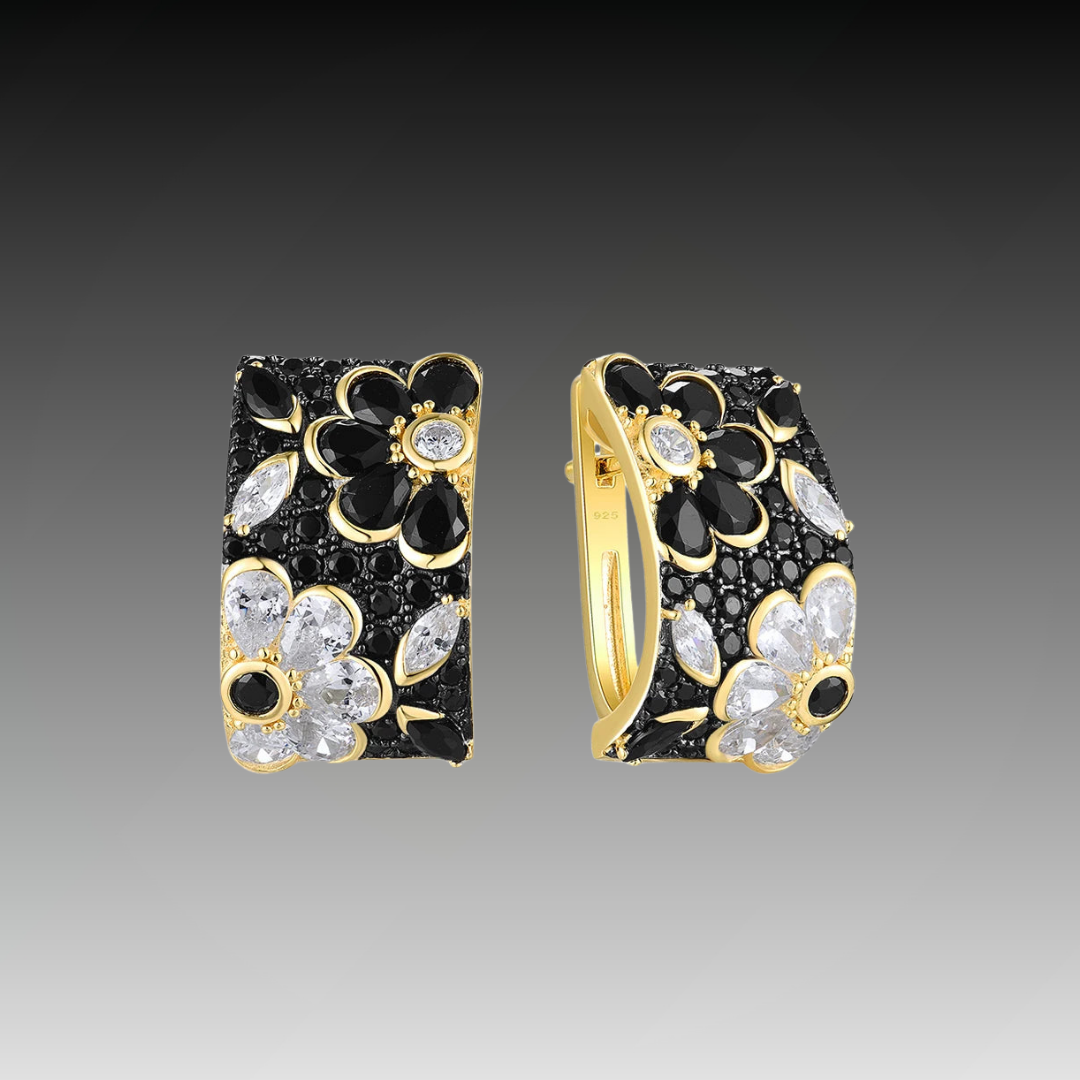 Floral huggie earrings with black and white stones set in gold-tone detailing