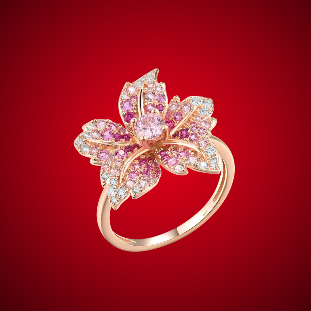 Rose gold floral ring with layered petals embellished in pink and white stones.