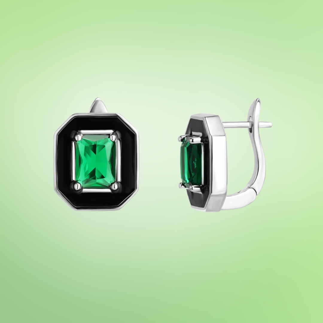 Silver earrings with black enamel octagonal frames and green emerald-cut stones at the center