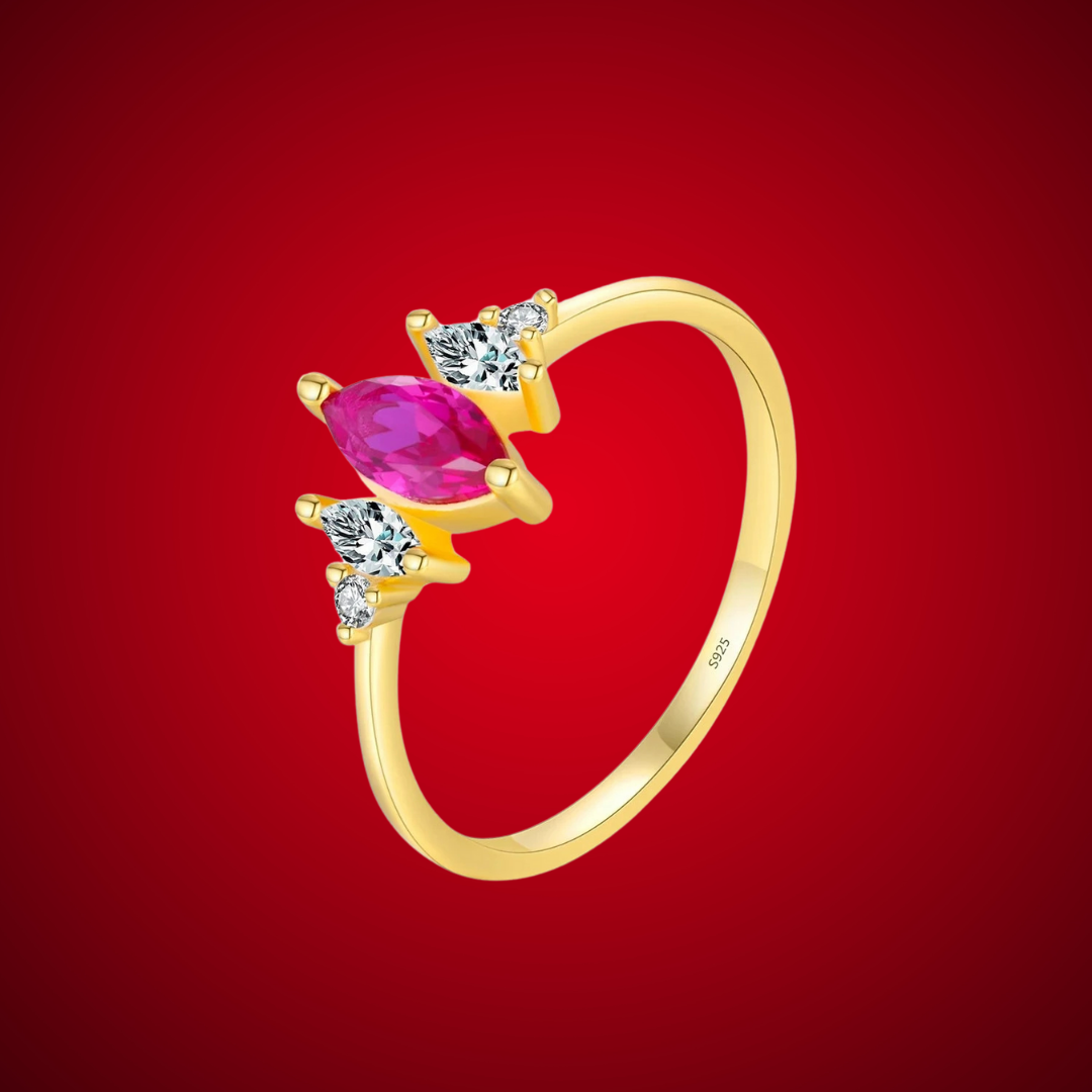 Gold-plated ring with marquise-cut ruby-pink stone and clear side accents