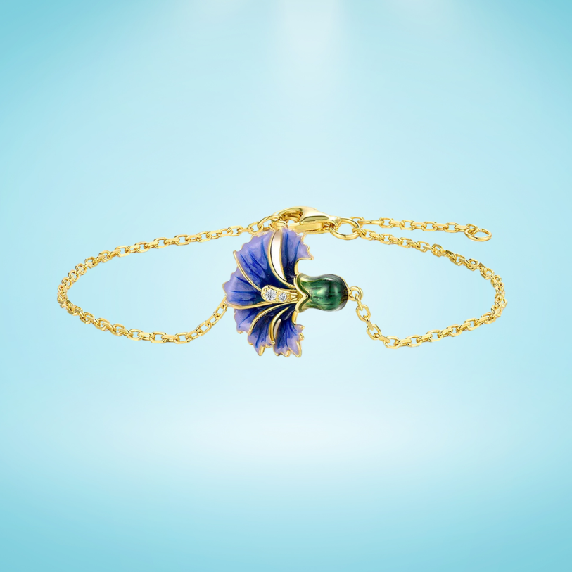 Gold bracelet with a purple and green enamel flower, detailed with sparkling stones on a fine chain