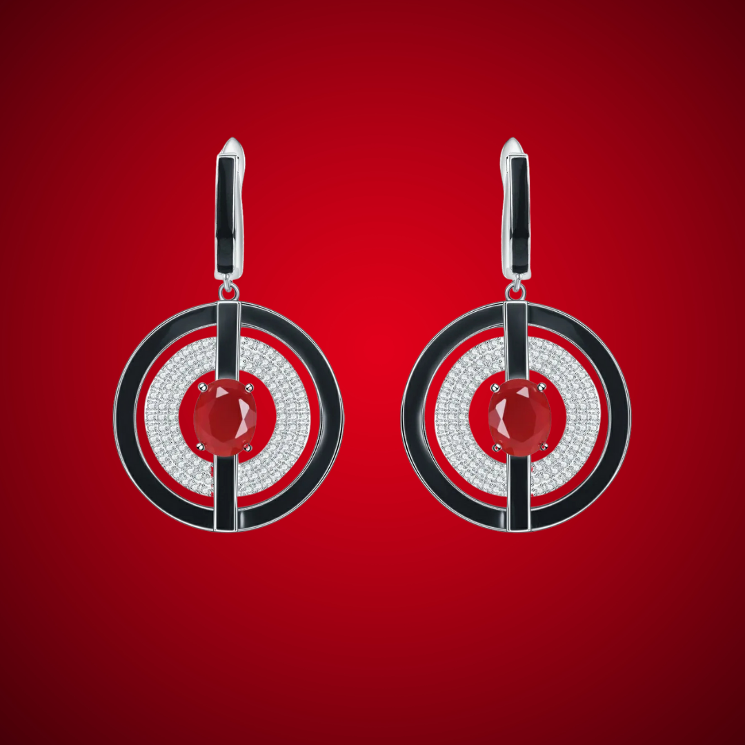 Drop earrings with circular geometric design, featuring black enamel borders, pavé crystals, and a central deep red gemstone.