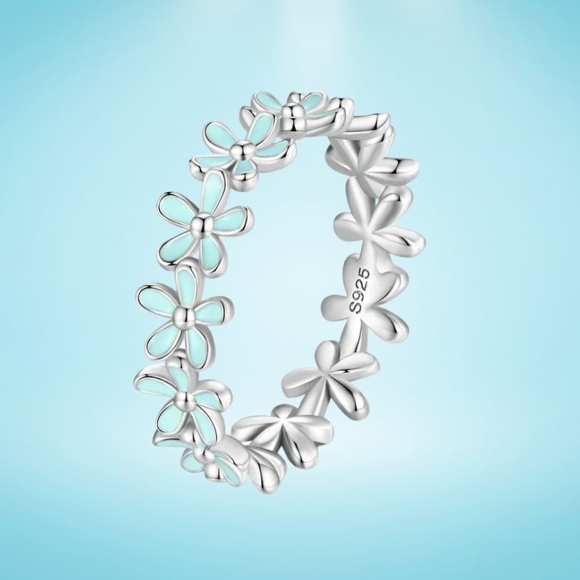 Silver floral band ring with alternating blue enamel and plain silver daisy motifs