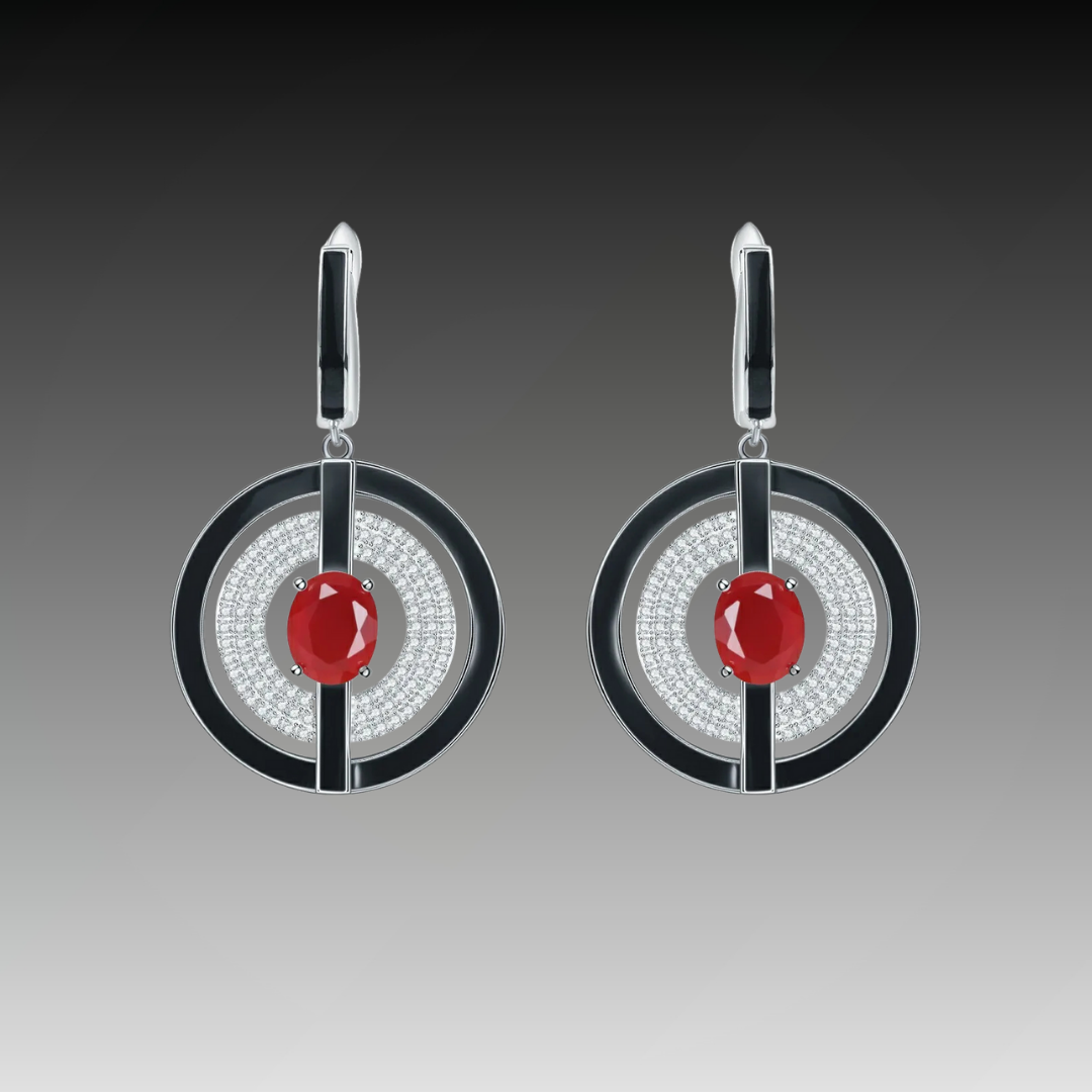 Sterling silver earrings with black enamel rings, pavé-set stones, and central red oval gems, from the Obliqua design.