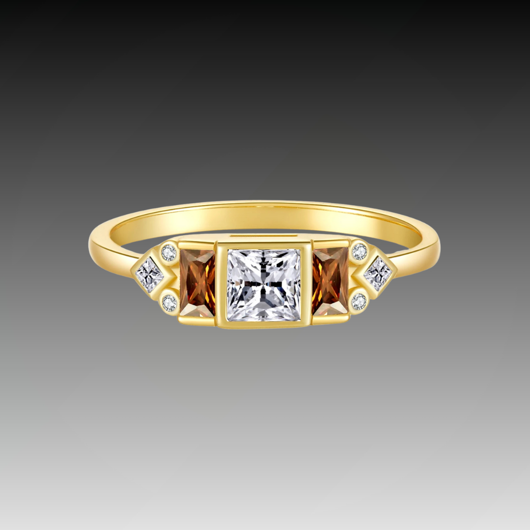 Gold ring with central white stone flanked by smoky square-cut stones and small accent gems