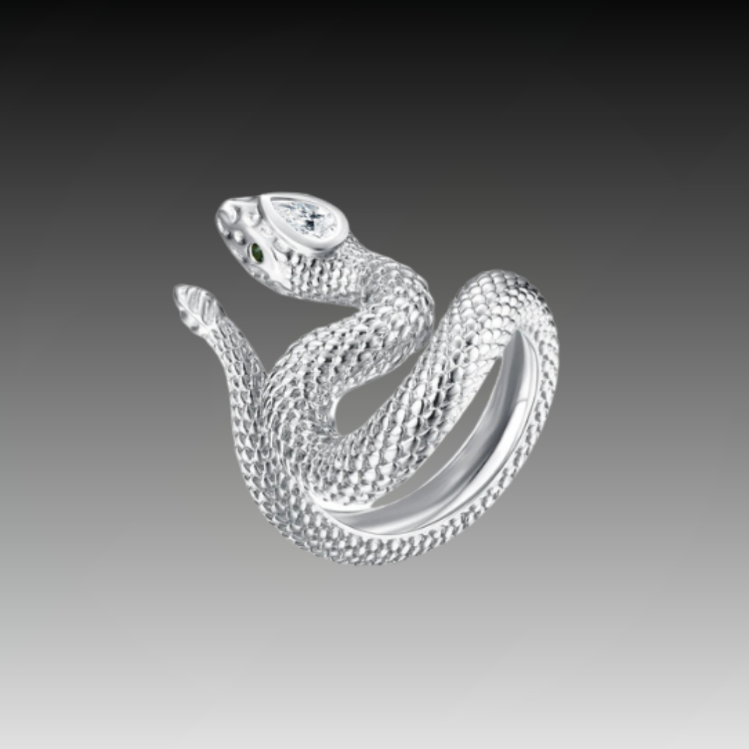 Textured silver snake ring coiled in a striking pose with green eyes and a marquise-cut clear stone set in the head.