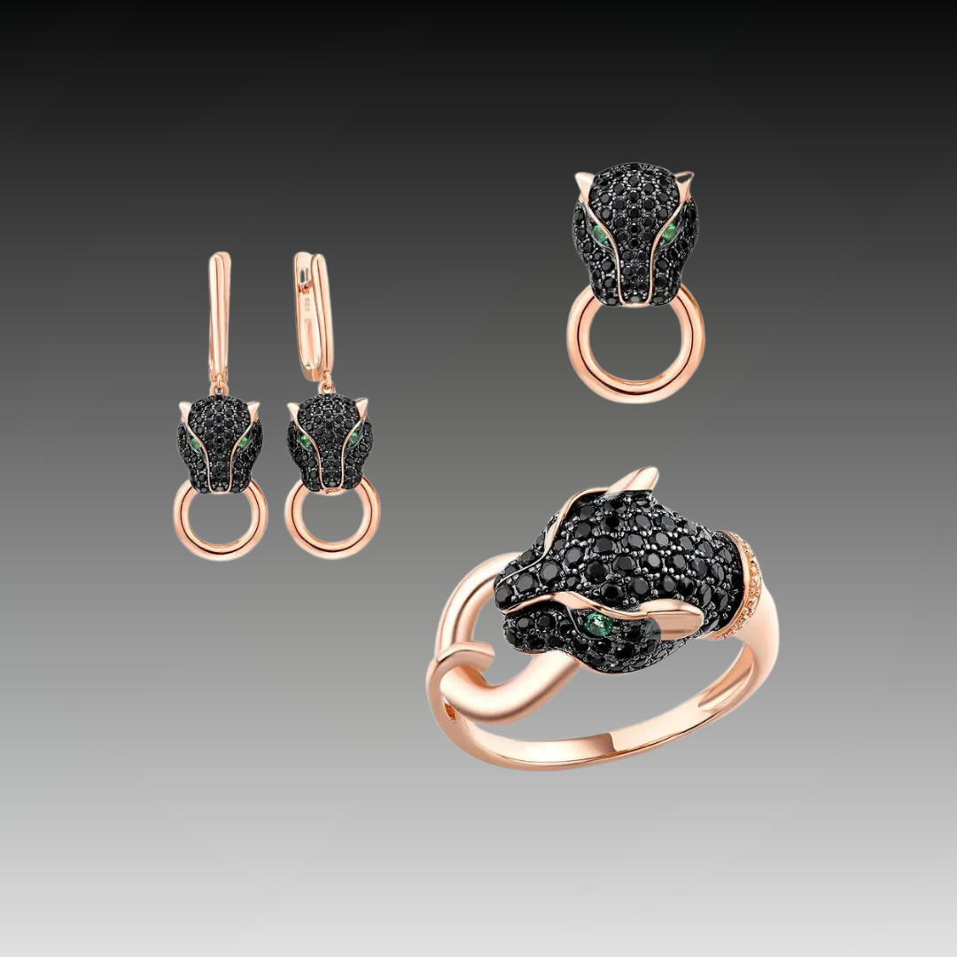 Rose gold jewelry set with panther head designs featuring black stones and green eyes, including earrings, ring, and pendant.