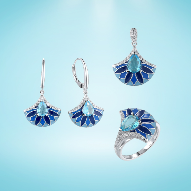Matching silver jewelry set with sky blue gemstones and fan-shaped floral enamel design in gradient blue tones