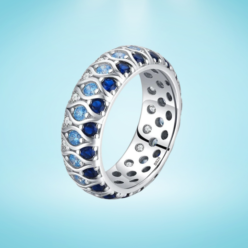 Sterling silver eternity band with alternating light and dark blue stones in a woven design