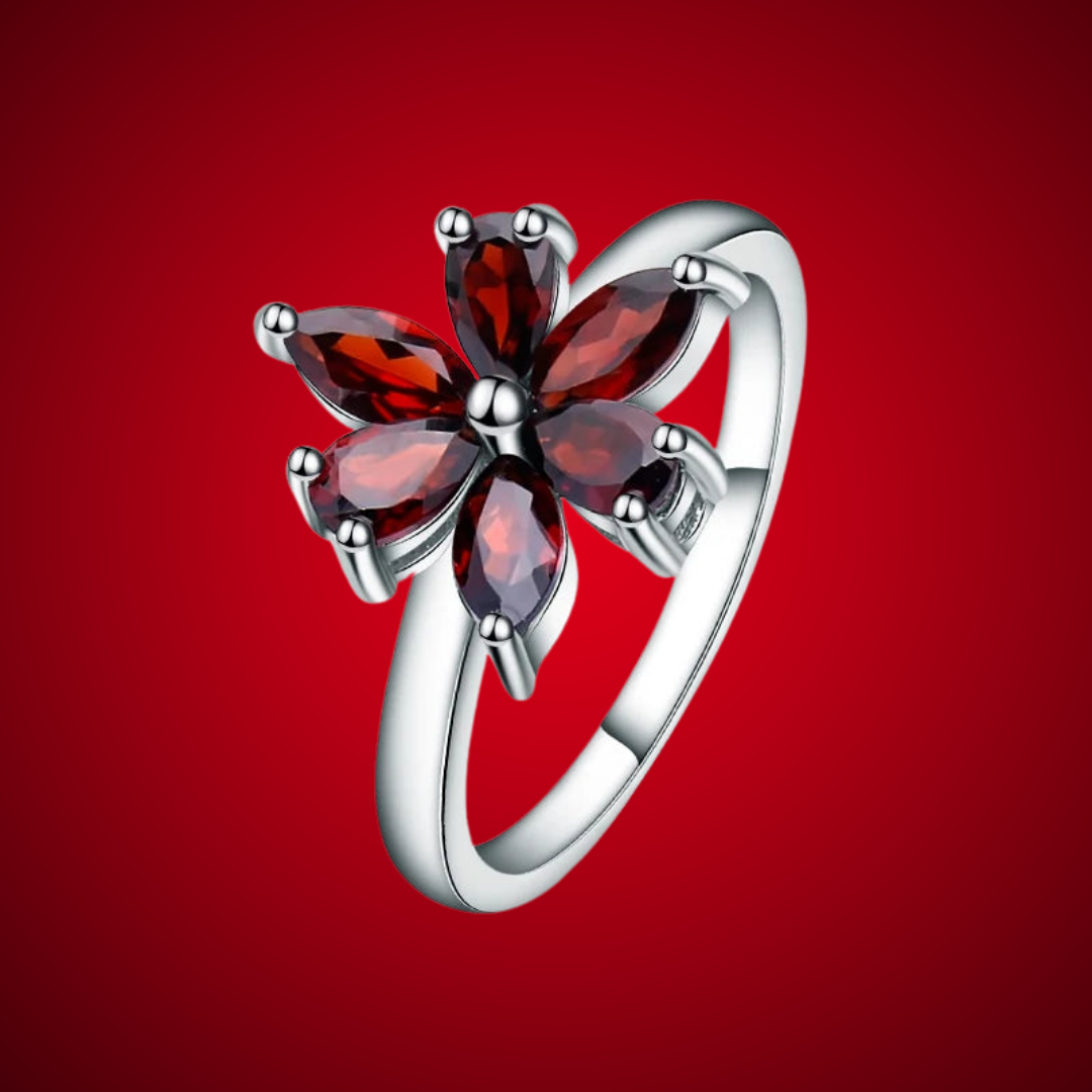 Silver ring featuring a flower design made of six marquise-cut deep garnet-red stones, from the Rossa Collection.