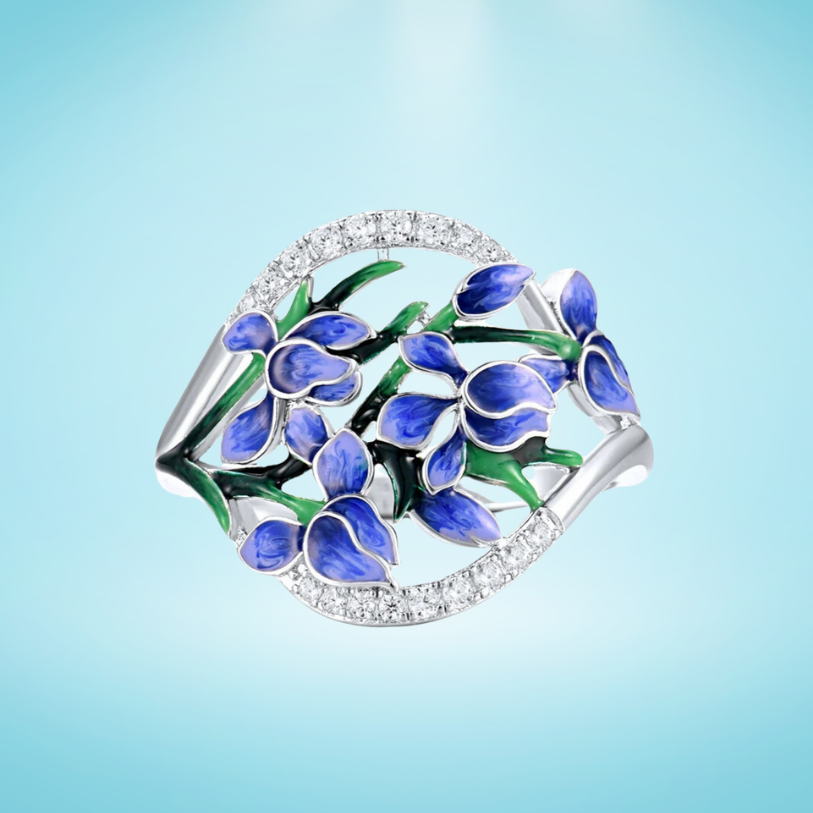 Silver ring featuring blue floral enamel vines and a partial arc of white stones