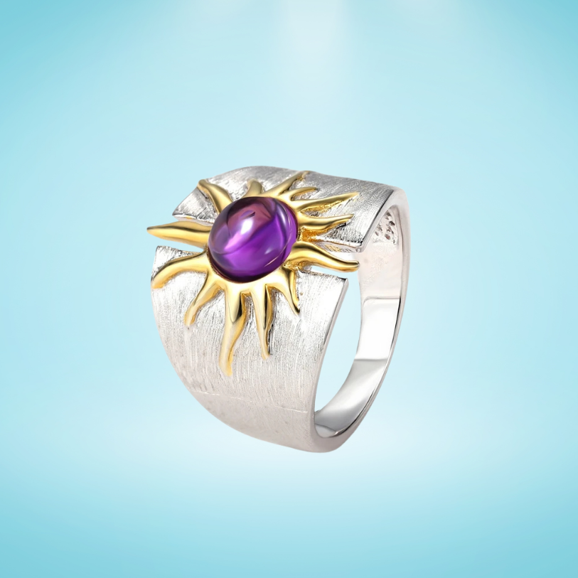 Textured sterling silver ring with golden sun design and central purple cabochon gemstone