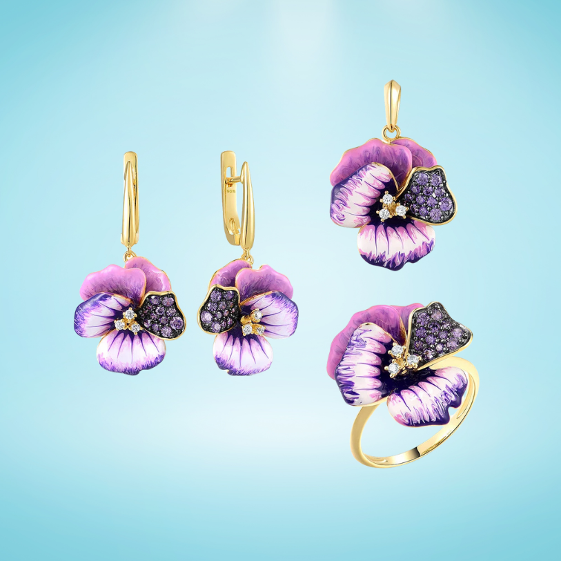 Gold jewelry set with violet enamel pansy flowers and pavé purple stones, including earrings, pendant, and matching ring