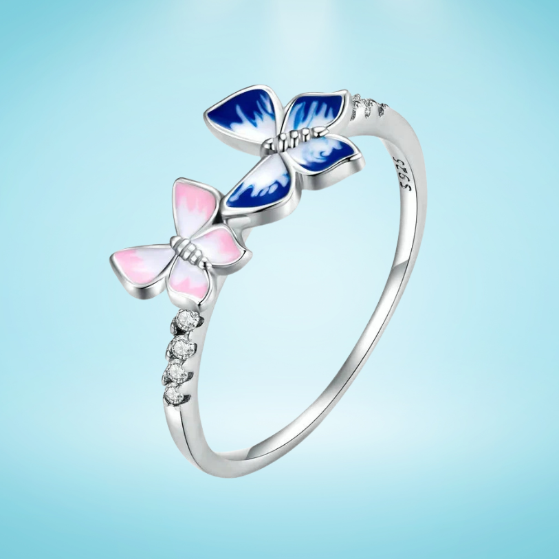 Delicate silver ring with pink and blue enamel butterflies and small white stones