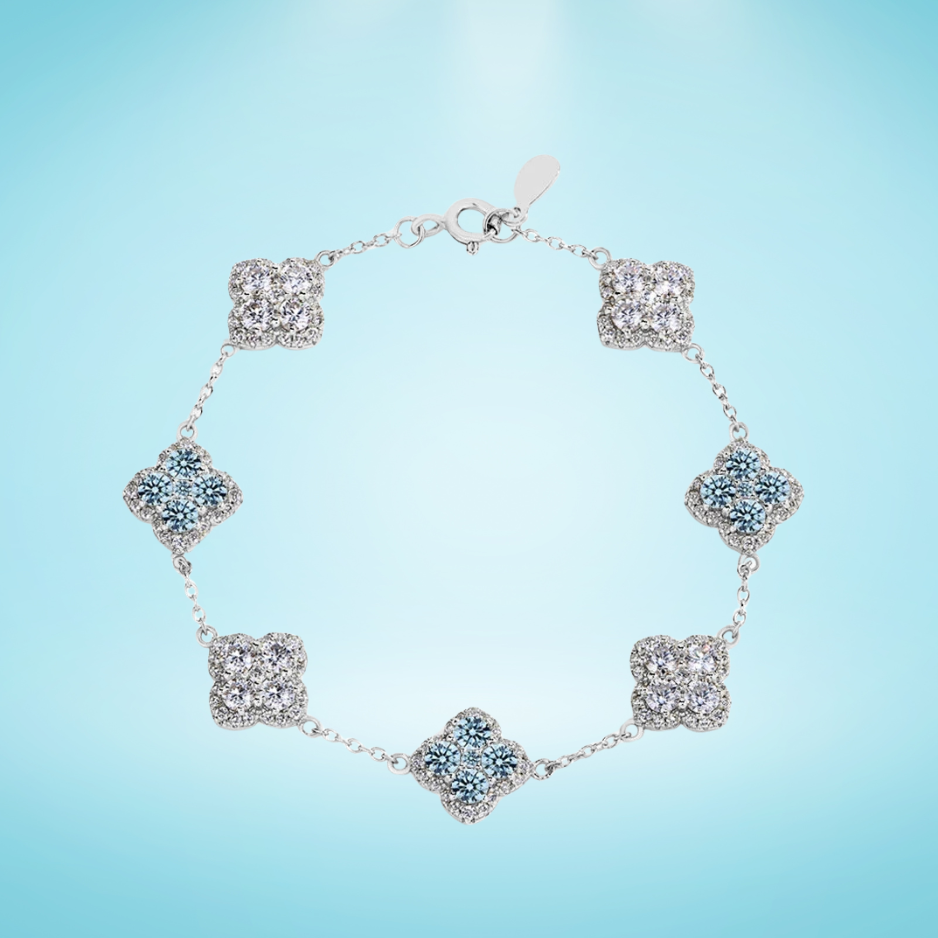 Silver bracelet featuring alternating sky blue and clear crystal floral clusters linked by a fine chain