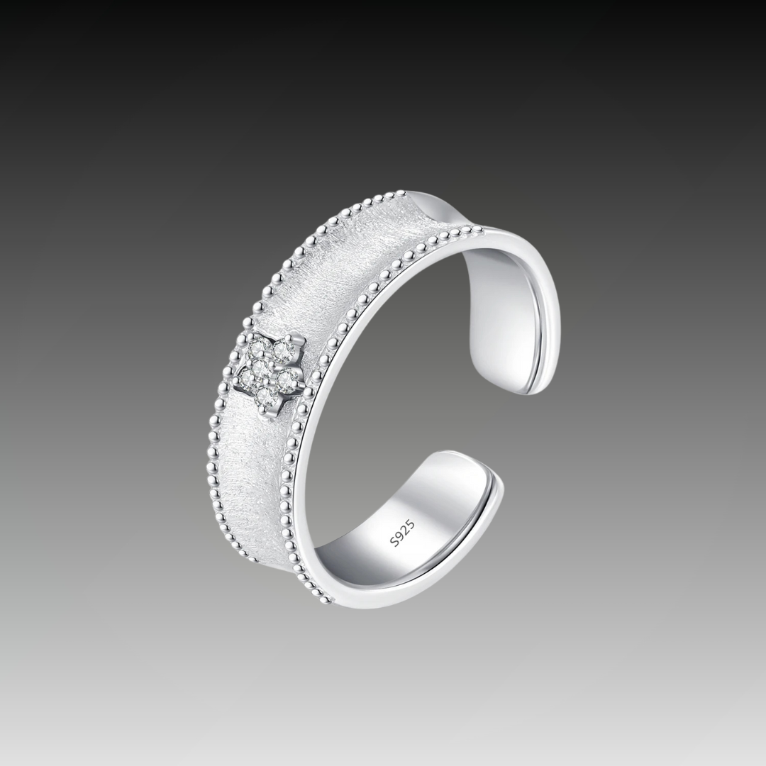 Sterling silver ring with a sleek, minimalist design featuring a thin band and a subtle clear gemstone accent