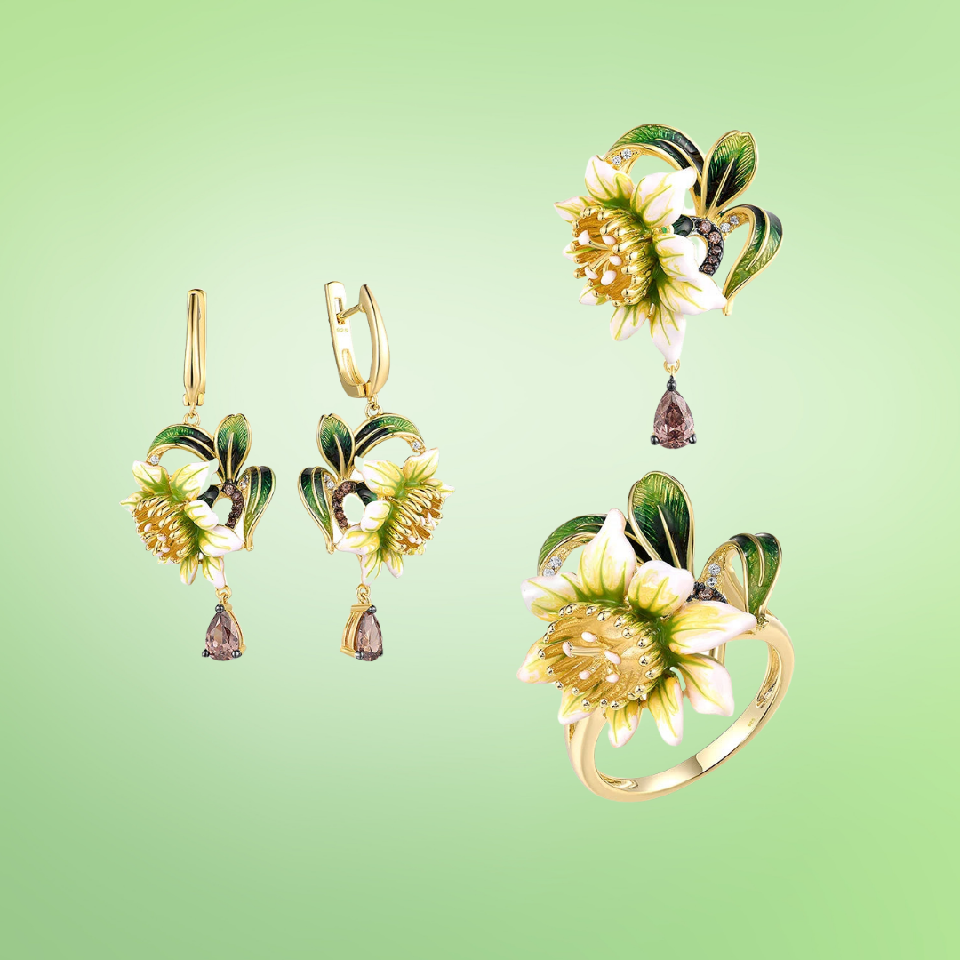 Gold floral jewelry set with white and green enamel petals, gold detailing, and brown teardrop stones