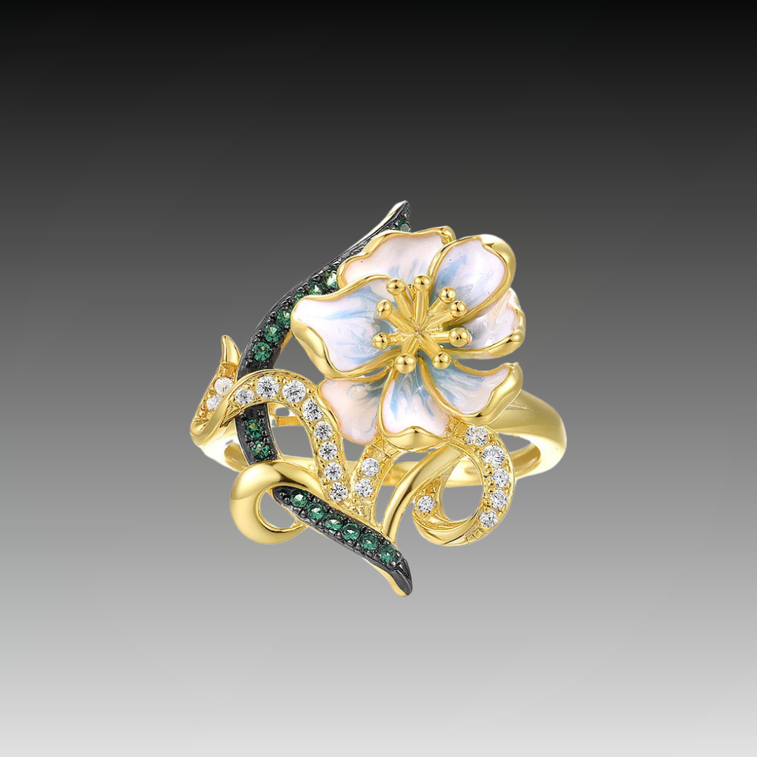 Gold ring with pastel enamel flower, green and clear stones on entwined vine-like details, from the Nastro Verde line.