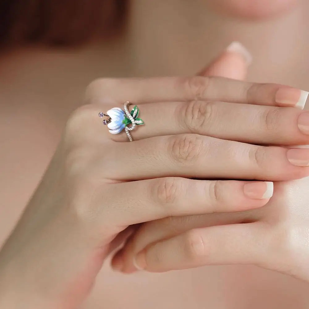 Campanula ring with hand-painted white and blue enamel flower, green leaves, and pavé detailing – Azzurro Collection