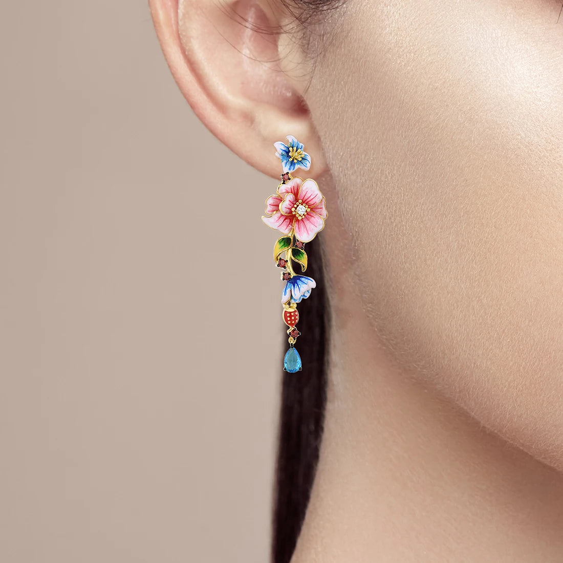 Gold-plated drop earrings with pink, blue, and red enamel flowers and teardrop blue gemstones