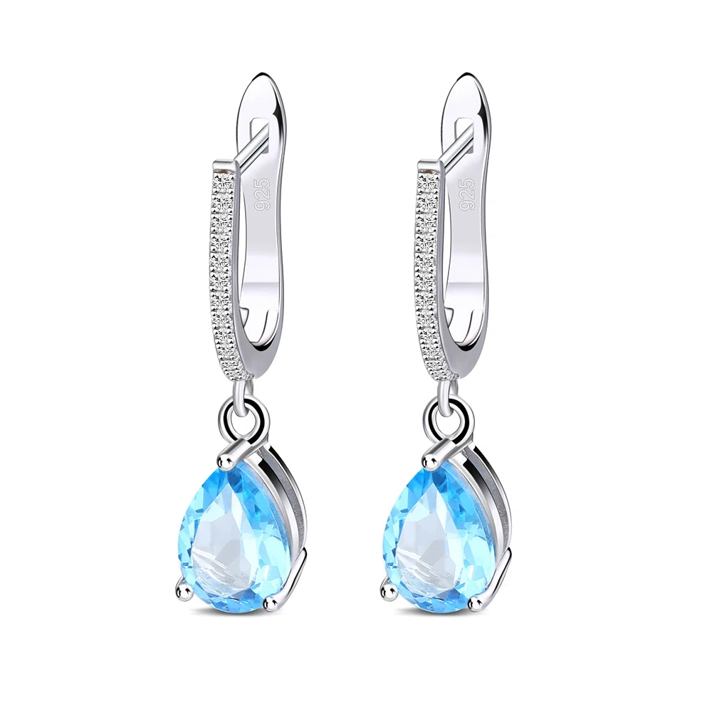 Set of three sterling silver drop earrings with pear-shaped stones in blue, navy, and violet, accented with pavé-set crystals