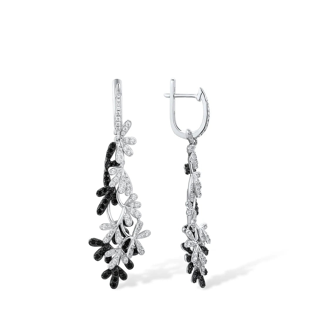 Long silver earrings with interwoven black and white gemstone-studded olive leaf designs.