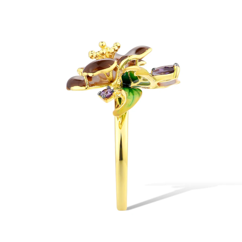Gold ring with deep purple flower enamel, green leaves, and amethyst-like stones