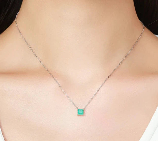 Square light green gemstone pendant on a fine gold chain.