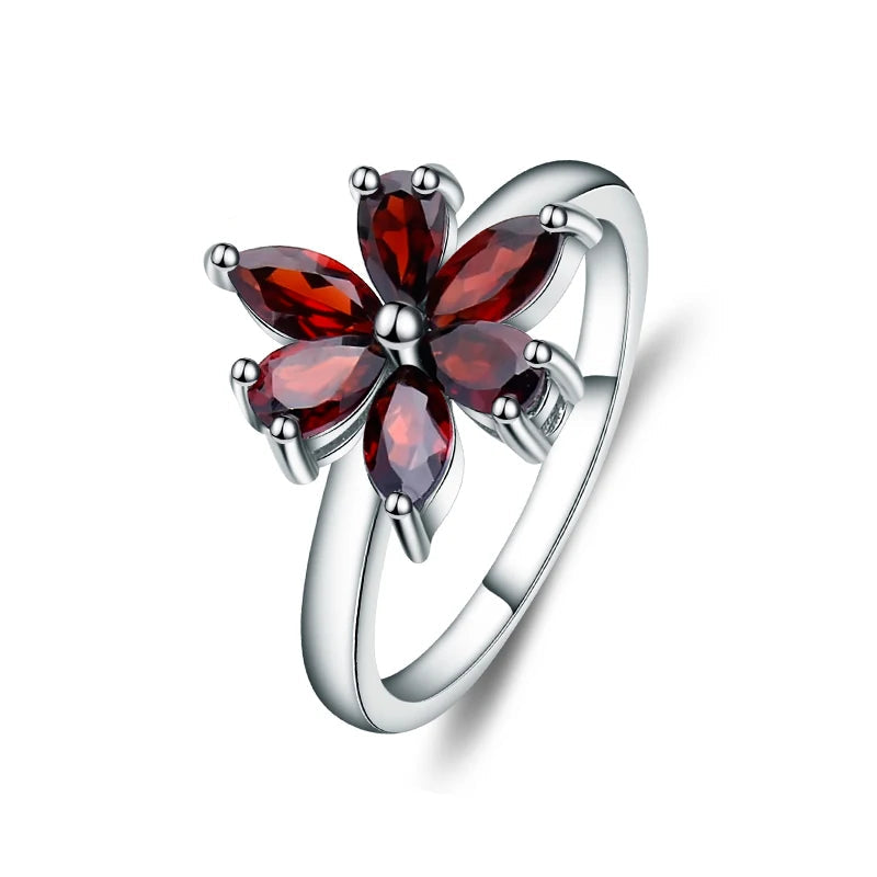 Silver ring featuring a flower design made of six marquise-cut deep garnet-red stones, from the Rossa Collection.
