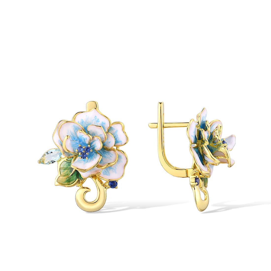 Gold-tone enamel earrings shaped like white and sky blue flowers with green leaves and sparkling stones.
