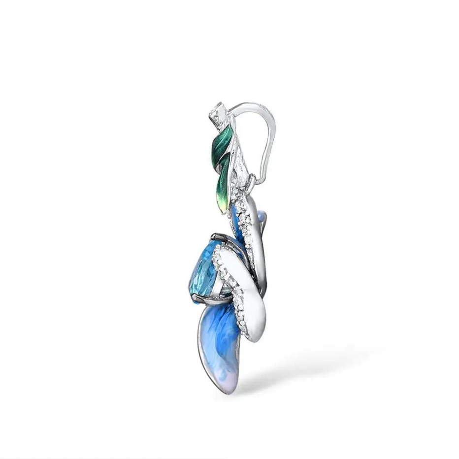 Floral silver pendant with hand-painted blue enamel petals, a teardrop-shaped aquamarine gemstone center, and a green enamel leaf accent