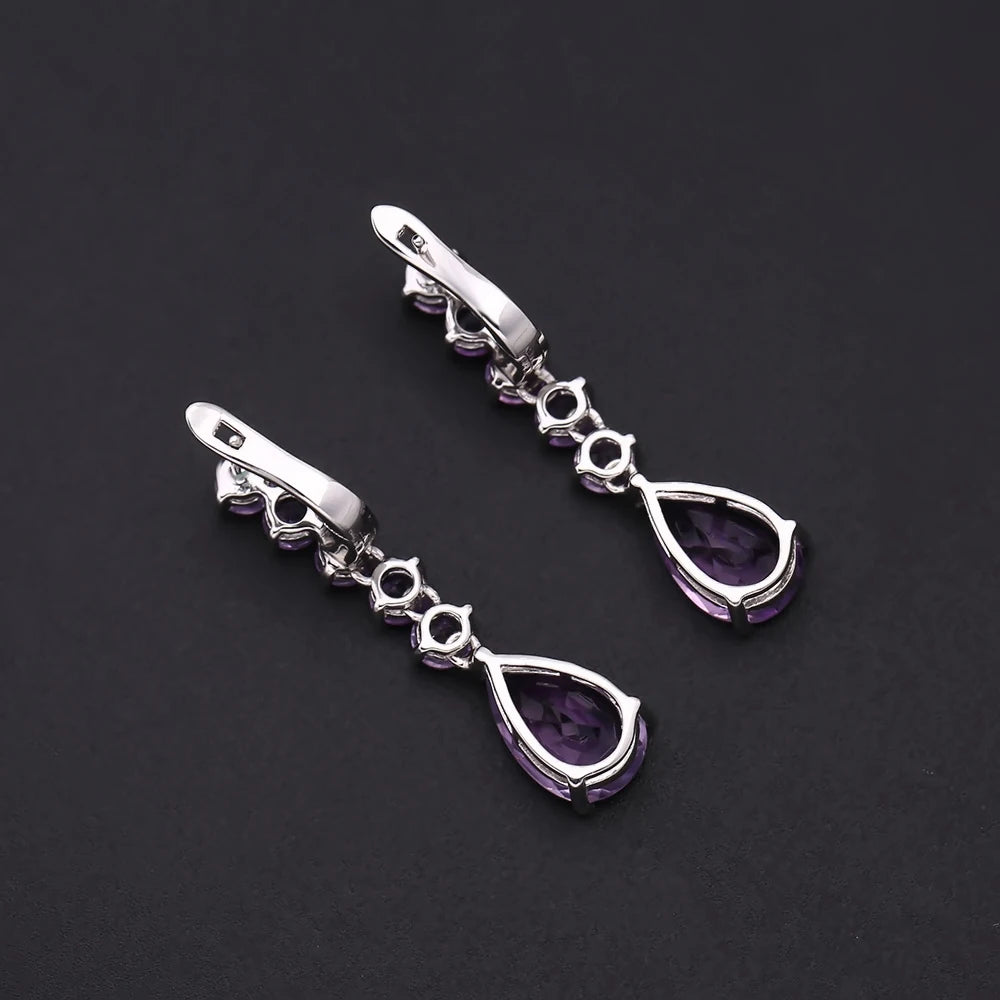 Sterling silver drop earrings with a vertical line of round amethyst stones and teardrop-shaped violet gemstones