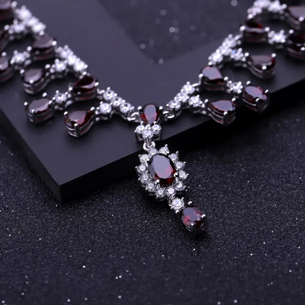 Necklace with red gemstones and clear stones on a black background